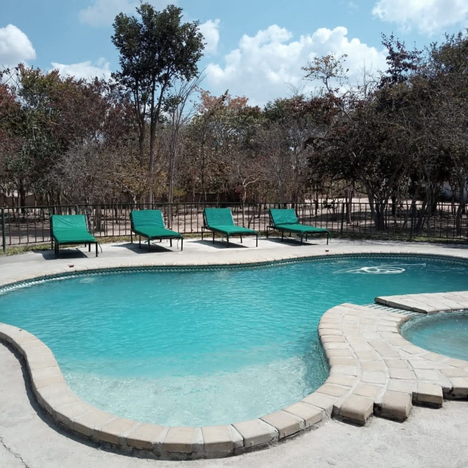 Turquoise pool and loungers at Lulu’s Pleasure Resort
