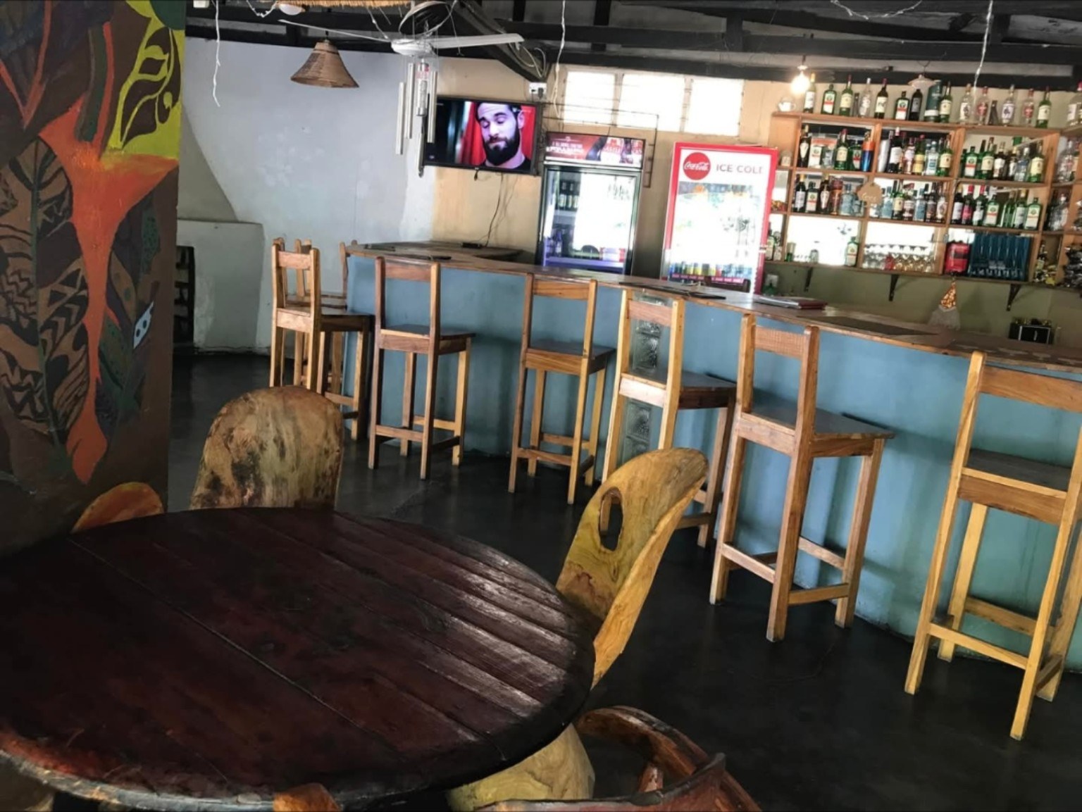 Bar with stools and television screens