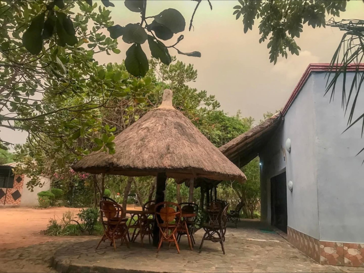 Thatched garden shelter with seating