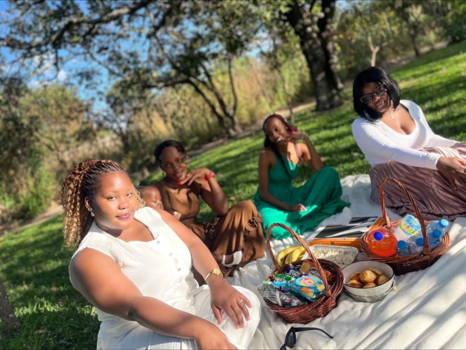 A regular ladies group enjoying a picnic together in the resort garden