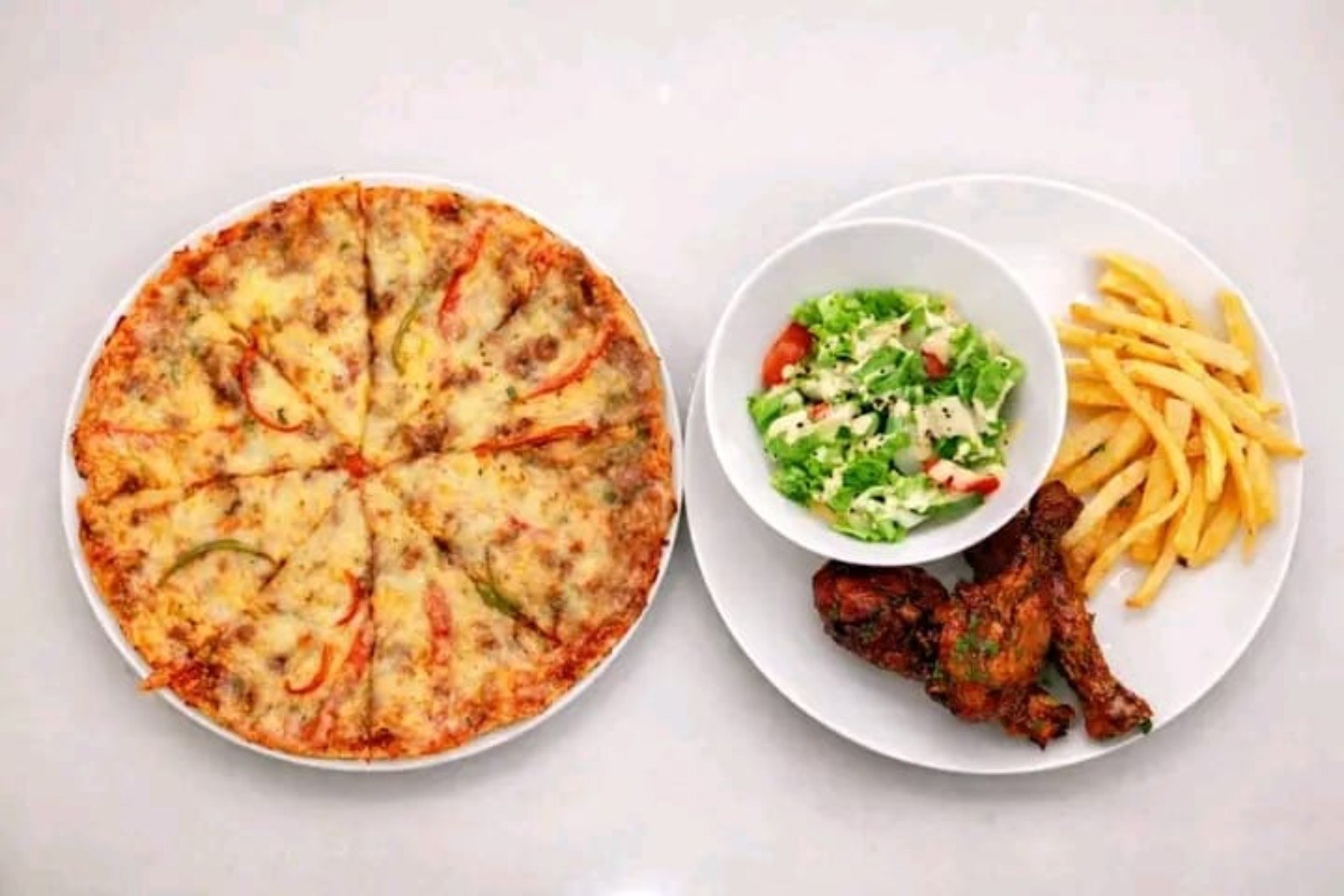 Pizza, chicken, chips and salad.