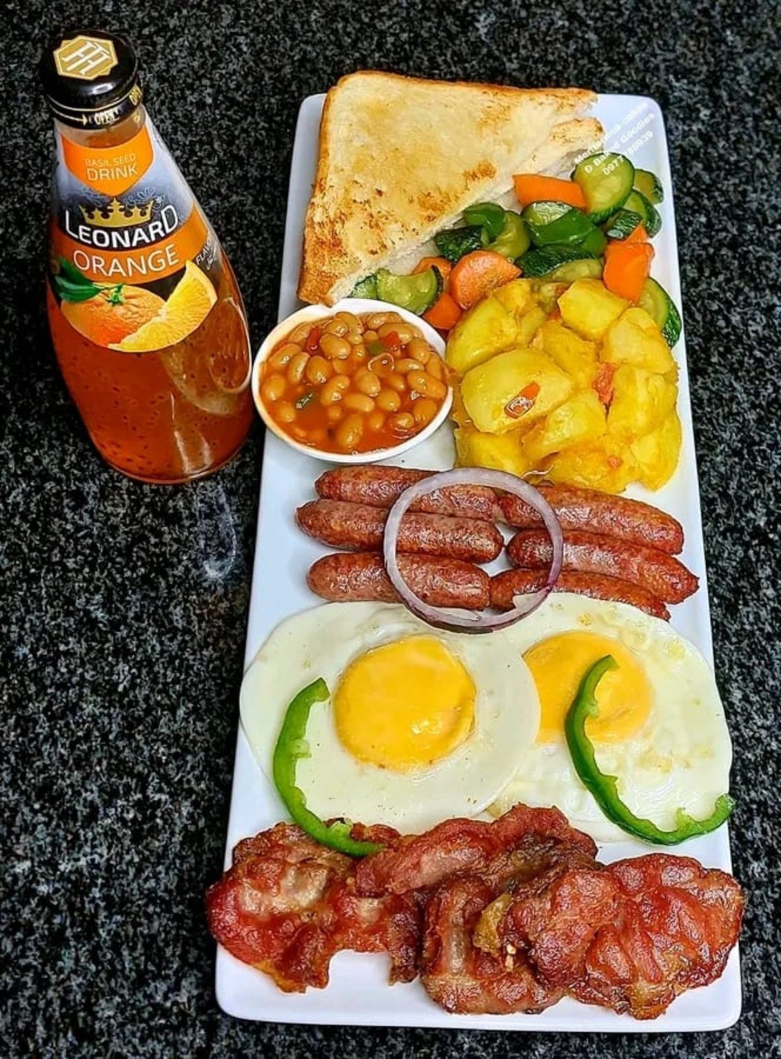 Eggs, sausages, bacon, toast and sides.